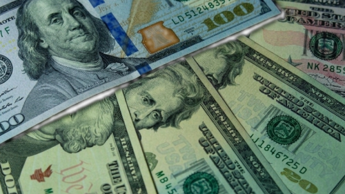 US dollar bills representing the DXY index strength that drives green coffee commodity pricing